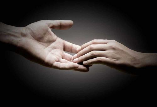 hand reaching to another hand